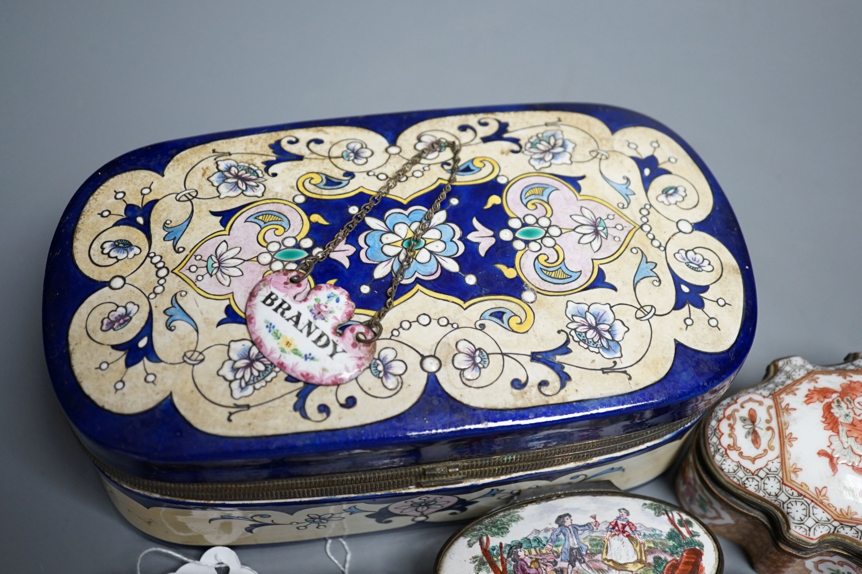 A group of five English and Continental enamel and porcelain patch and other boxes and two spirit labels, largest 20 x 8cm